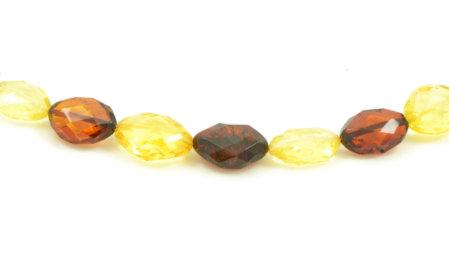 Large faceted set of multicolored amber in olive shape
